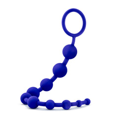 Side angle of indigo blue silicone anal beads showing flexible strand and loop handle
