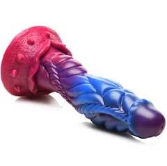 Side angle of Intruder alien dildo lying flat, showing full-length twisted shaft and pink base