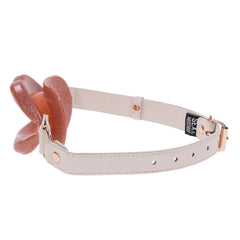 Side angle of Peaches n CreaMe Lips gag showing adjustable cream strap and brand label