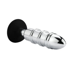 Side angle of ribbed stainless steel anal plug showing bullet-shaped tip and black silicone suction cup