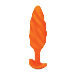 Close side view of the b-Vibe Swirl plug highlighting diagonal swirl ridges in orange silicone