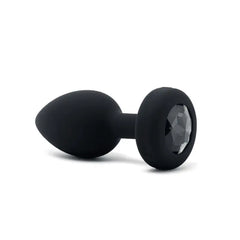 Side view of black silicone anal plug featuring faceted black diamond jewel base