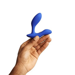 Side view of blue We-Vibe Vector+ prostate massager balanced in an open hand