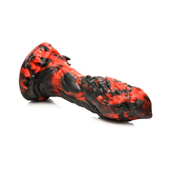 Side-lying view of the Reaper Dildo revealing layered scale-like texture along the shaft