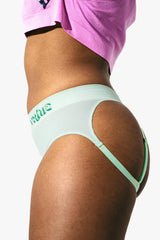 Side view on model highlighting cutout strap detail and high-cut silhouette of mint briefs