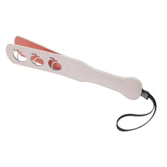 Side view of pink impression paddle showing layered construction with coral underside and wrist strap