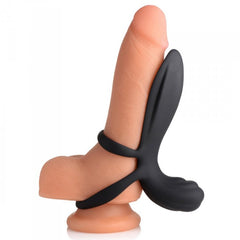 Side profile of black silicone girth enhancer fitted over a realistic model, showing dual-ring base design
