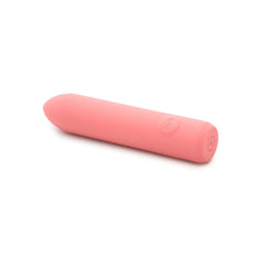 Side profile of The Bullet vibrator lying flat highlighting tapered tip and cylindrical shape