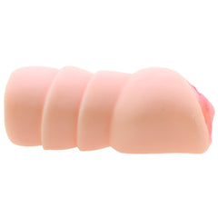 Side profile of the compact flesh-tone stroker showing segmented ridged exterior