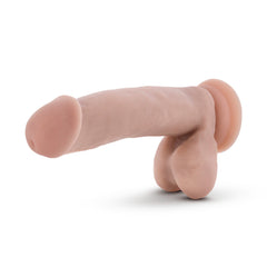 Side profile of Coverboy Pool Boy beige dildo lying flat, highlighting suction cup base