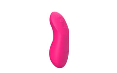 Side profile of electric pink clitoral vibrator with subtle control buttons on smooth silicone