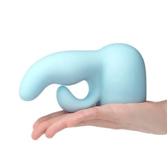 Side profile of Le Wand Dual soft blue silicone attachment resting on open palm