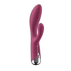 Side profile of red rabbit vibrator displaying clitoral arm and control strip along handle