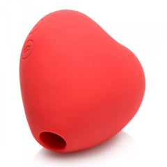 Side profile of the red silicone heart-shaped stimulator revealing the small suction nozzle and control button