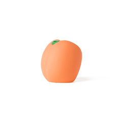 Side profile of the rounded peach silicone stroker with small green leaf-shaped accent cap