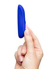 Side profile of slim blue silicone ROMP Party vibrator held between two fingers