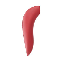Side profile of the We-Vibe Melt coral stimulator highlighting its ergonomic curved shape