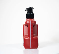 Side view of red Cock Oil pump bottle revealing embossed fluid measurement markings