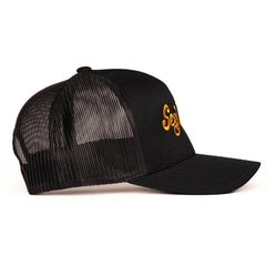 Side view of Sexy Living black mesh trucker cap showing breathable back panel construction