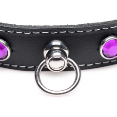 Close-up of silver O-ring hardware and purple faceted rhinestone studs on black leather