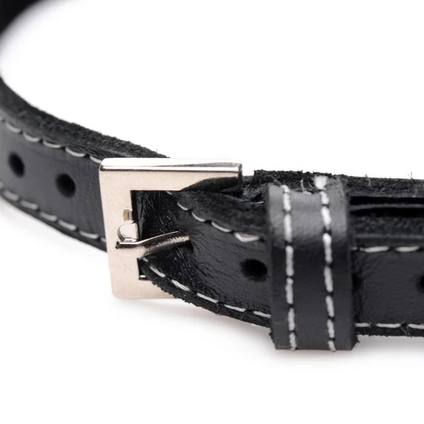 Close-up of silver pin buckle and white contrast stitching on black leather choker band