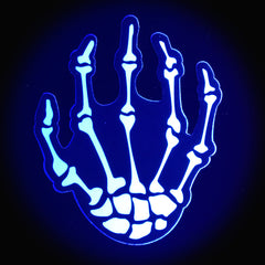 Single skeleton hand pastie glowing under UV light, showing blacklight-reactive white detail