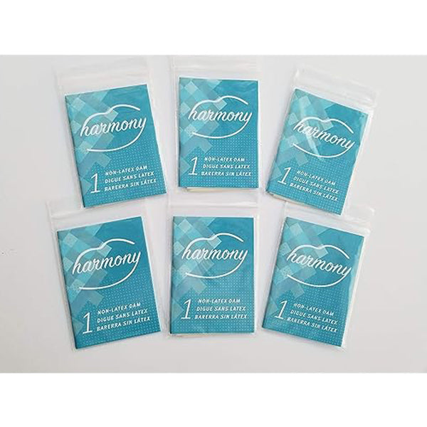 Six individually wrapped Harmony non-latex dams in teal foil packets, laid flat