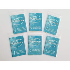 Six individually wrapped Harmony non-latex dams in teal foil packets, laid flat