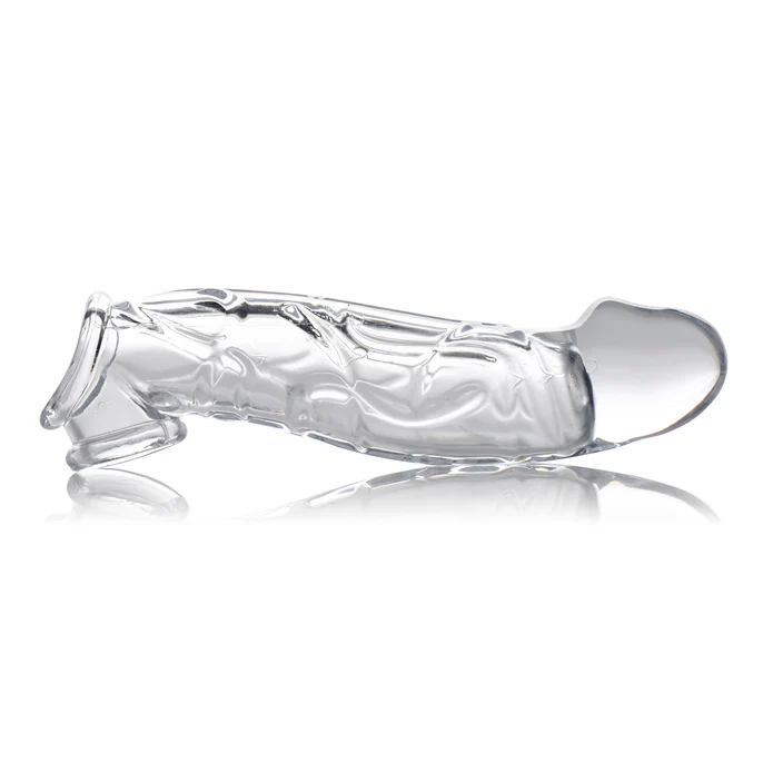 Size Matters 2 Inch Clear Extender Sleeve shown horizontally, featuring textured transparent TPE shaft