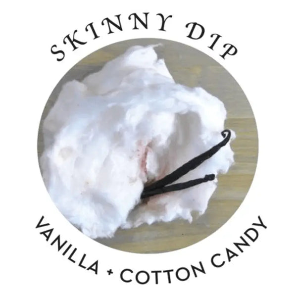Skinny Dip scent profile showing fluffy cotton candy and vanilla bean pods on a wooden surface
