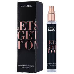 Slim clear glass spray bottle with rose-gold pump cap next to bold black rectangular perfume box