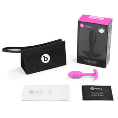 Snug Plug 1 pink shown with storage pouch, box, user guide, and anal play booklet