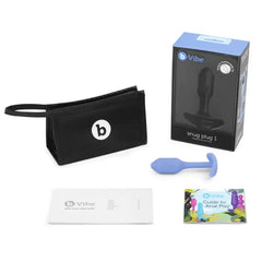 Snug Plug 1 unboxed beside storage pouch, box, and b-Vibe anal play guide booklet