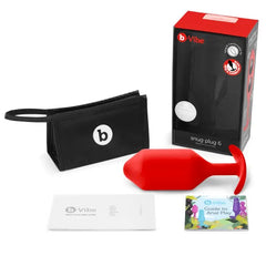 Snug Plug 6 red plug displayed with storage pouch, user guide, and anal play booklet