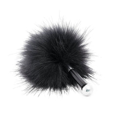Close-up of soft black marabou feather tickler head with black handle and silver tip against white background