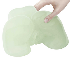 Soft glow-in-the-dark doggie-style masturbator shown in hand to illustrate flexible feel