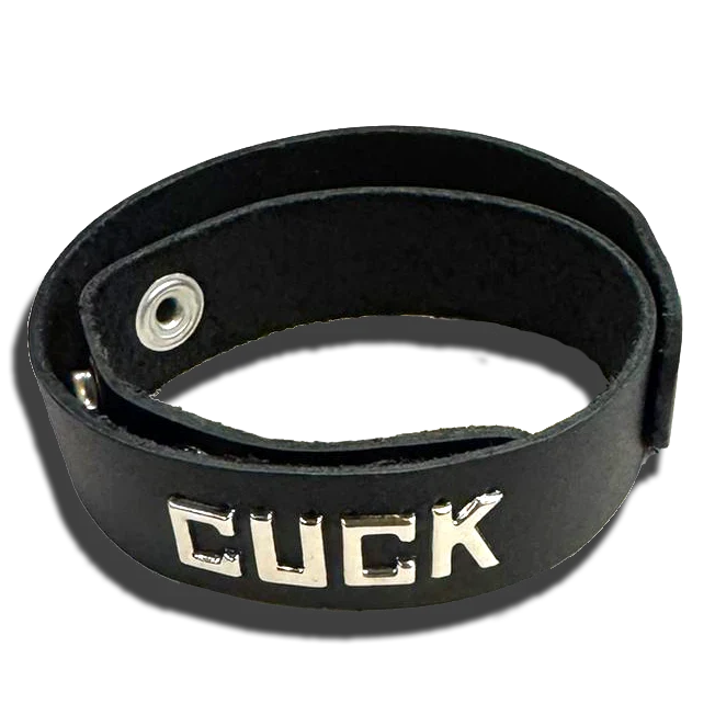 Spartacus CUCK black leather wristband collar with silver snap closure and metal lettering