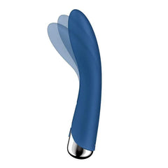 Close-up of Spinning Vibe 1 curved tip illustrating the sweeping rotation arc in blue silicone