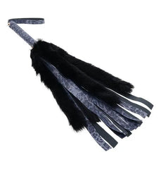 Sportsheets faux fur flogger shown at an angle, highlighting mixed fur and satin tails