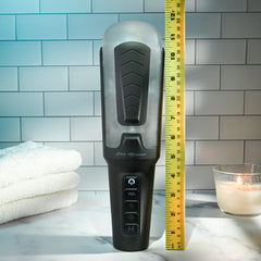 Squeeze Play stroker beside ruler showing approximately 11 inches total height on marble surface