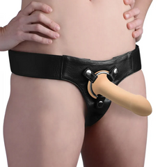 Squeeze-It Squeezable Phallic Dildo in flesh tone worn with a black leather harness