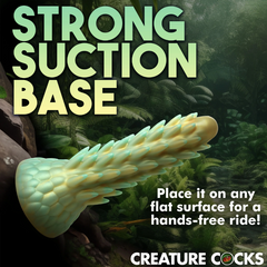 Stegosaurus dildo shown horizontally on flat surface demonstrating strong hands-free suction base