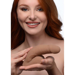 Strap U Large Bulge Packer Dildo Medium held in model's hands, showing realistic medium-tone silicone form