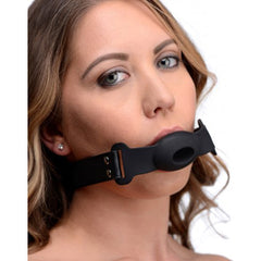 Strict Hollow Silicone Gag worn by a woman, showing the black breathable ball and strap