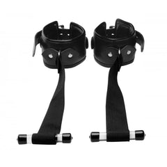 Strict over-door wrist restraints laid flat, showing faux-leather padded cuffs and nylon straps