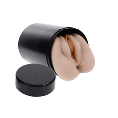 Stroker insert tilted out of the canister on its side with the black cap removed nearby