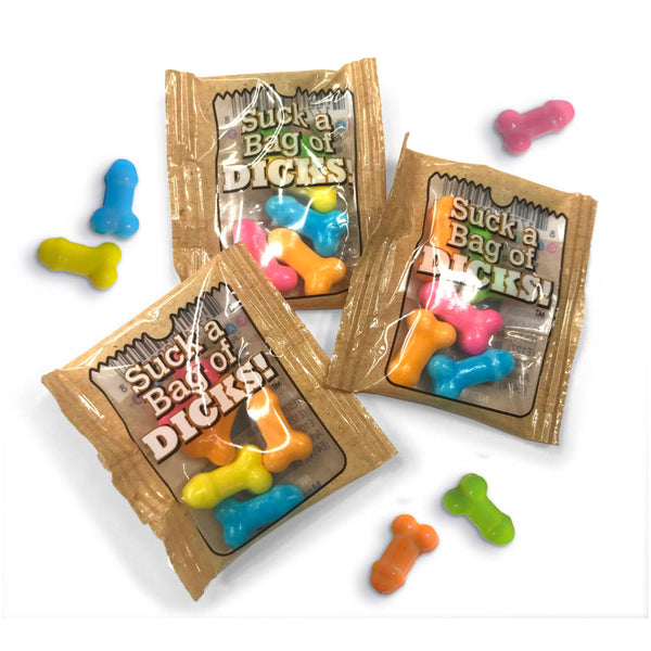 Suck a Bag of Dicks Candy individual foil packets with colorful novelty candies scattered around