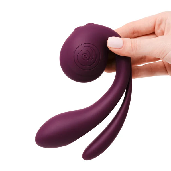 SVibe Snail GIZI Pro vibrator in grape, held in hand, showing dual-arm silicone design with spiral detail