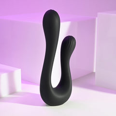 The Swan matte black dual vibrator standing upright against soft purple backdrop
