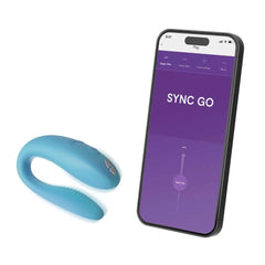 Sync Go couples vibrator beside smartphone displaying the We-Vibe app control interface